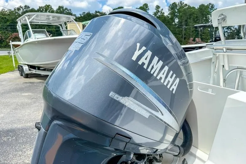 Slide: The Image of Yamaha outboard motor on a 1997 Contender 21 Open boat, parked outdoors. - 15