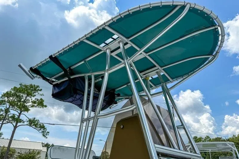 Slide: The Image of T-top of a 1997 Contender 21 Open boat against a cloudy sky. - 9