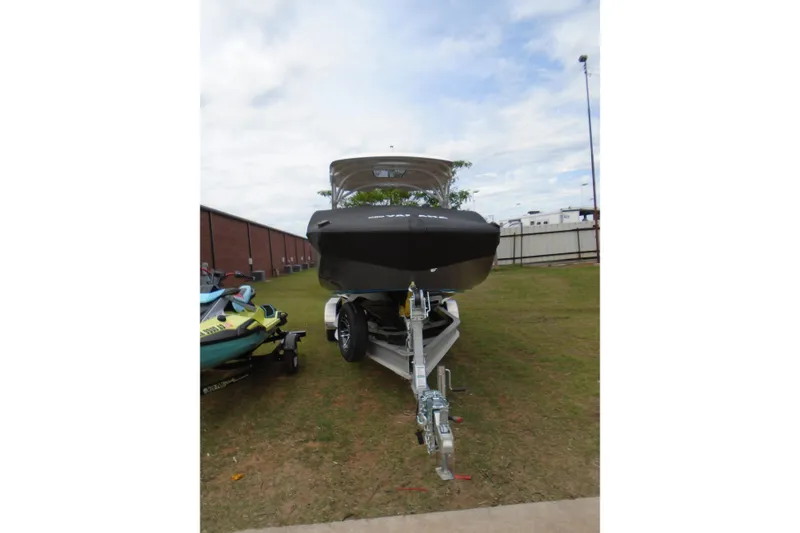 Slide: The Image of 2022 Yamaha Boats 275SD on trailer, parked outdoors under cloudy sky. - 2