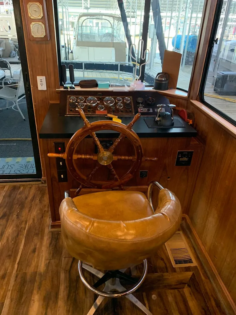 Slide: The Image of 1985 Sumerset 18x81 houseboat helm with wooden steering wheel. - 12