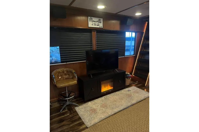 Slide: The Image of Cozy living area in 1985 Sumerset 18x81 houseboat with TV and electric fireplace. - 13