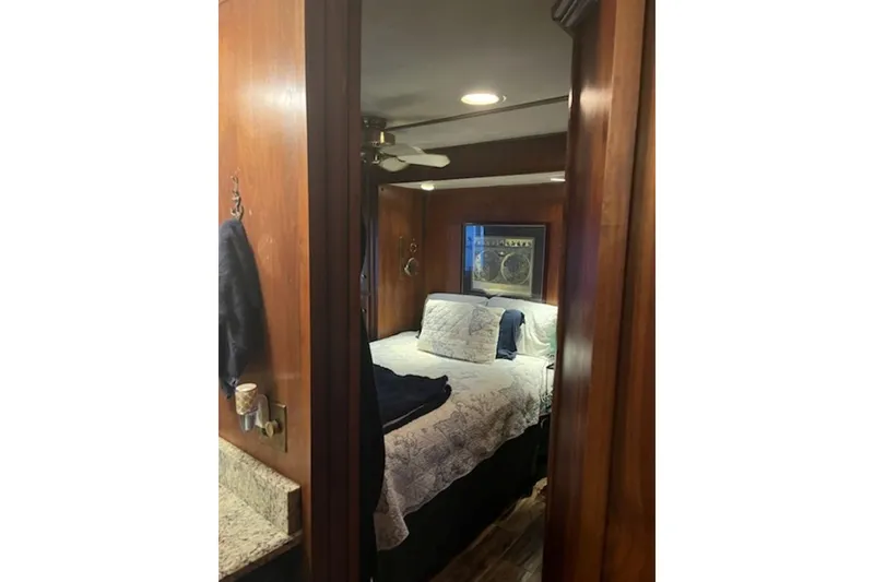 Slide: The Image of Cozy bedroom in 1985 Sumerset 18x81 houseboat with wood paneling and ceiling fan. - 19