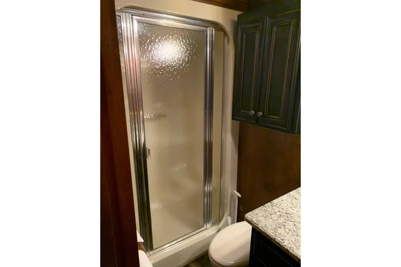 Slide: The Image of Bathroom in 1985 Sumerset 18x81 houseboat with shower, toilet, and granite countertop. - 20