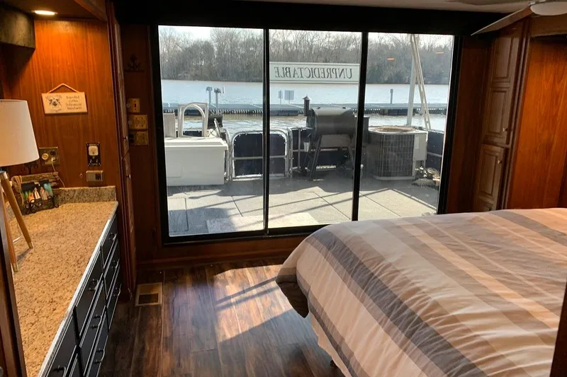 Slide: The Image of Bedroom interior of 1985 Sumerset 18x81 houseboat with lake view through large windows. - 21