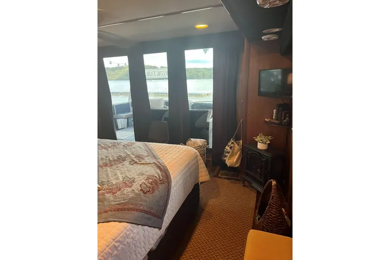Slide: The Image of Cozy interior of 1985 Sumerset 18x81 houseboat with lake view, bed, and decor. - 22