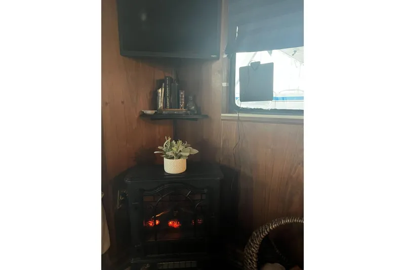 Slide: The Image of Cozy interior of 1985 Sumerset 18x81 with fireplace, TV, and potted plant. - 23