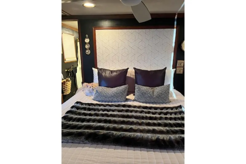 Slide: The Image of Luxurious bedroom interior in a 1985 Sumerset 18x81 houseboat with plush pillows and modern decor. - 24