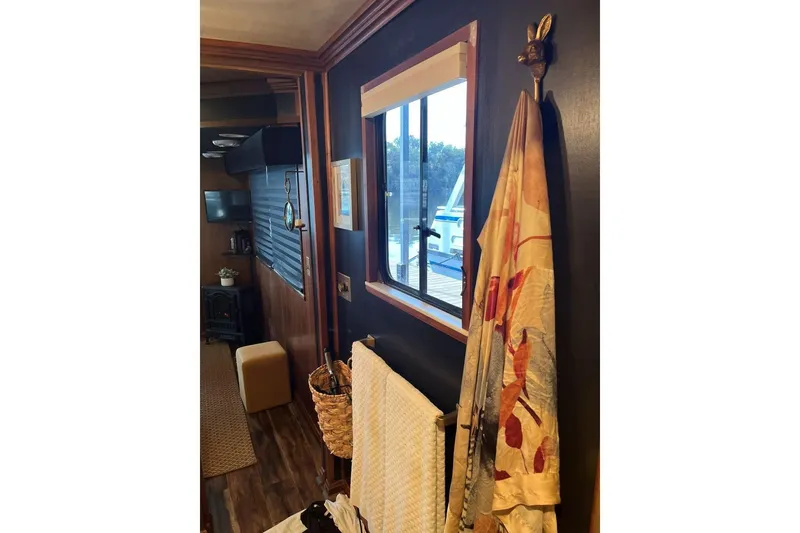 Slide: The Image of Interior of 1985 Sumerset 18x81 houseboat with window view and cozy decor. - 25