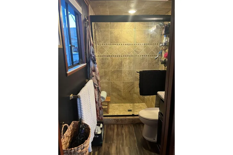 Slide: The Image of Compact bathroom with tiled shower in 1985 Sumerset 18x81 houseboat. - 26