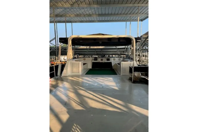 Slide: The Image of 1985 Sumerset 18x81 houseboat docked under a covered marina. - 29