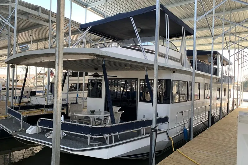 Slide: The Image of 1985 Sumerset 18x81 houseboat docked in a covered marina. - 4