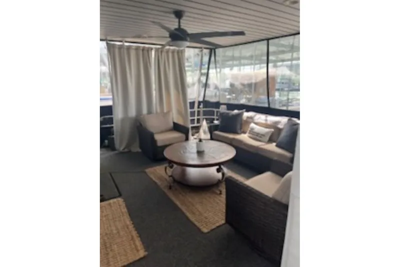 Slide: The Image of Cozy interior of 1985 Sumerset 18x81 houseboat with comfortable seating and ceiling fan. - 6