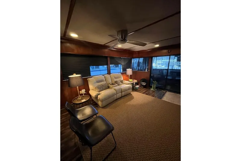 Slide: The Image of Cozy living area in 1985 Sumerset 18x81 houseboat with plush seating and modern decor. - 9