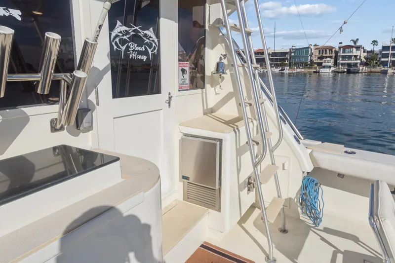 Slide: The Image of 1988 Viking 48 Convertible yacht deck with ladder and waterfront view. - 10