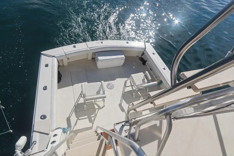 Slide: The Image of 1988 Viking 48 Convertible yacht deck with chairs, overlooking sparkling water. - 11