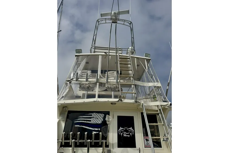Slide: The Image of 1988 Viking 48 Convertible yacht with tower and fishing rod holders, viewed from the stern. - 12