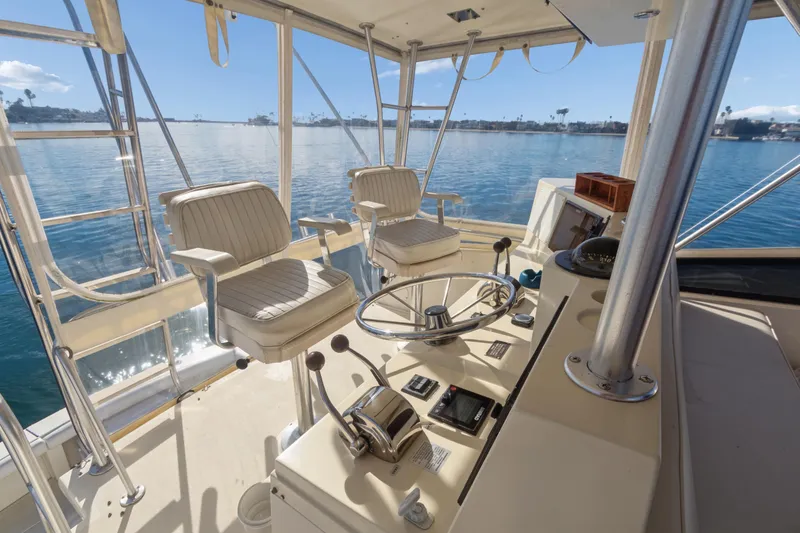 Slide: The Image of Helm of 1988 Viking 48 Convertible yacht with dual captain chairs and ocean view. - 13