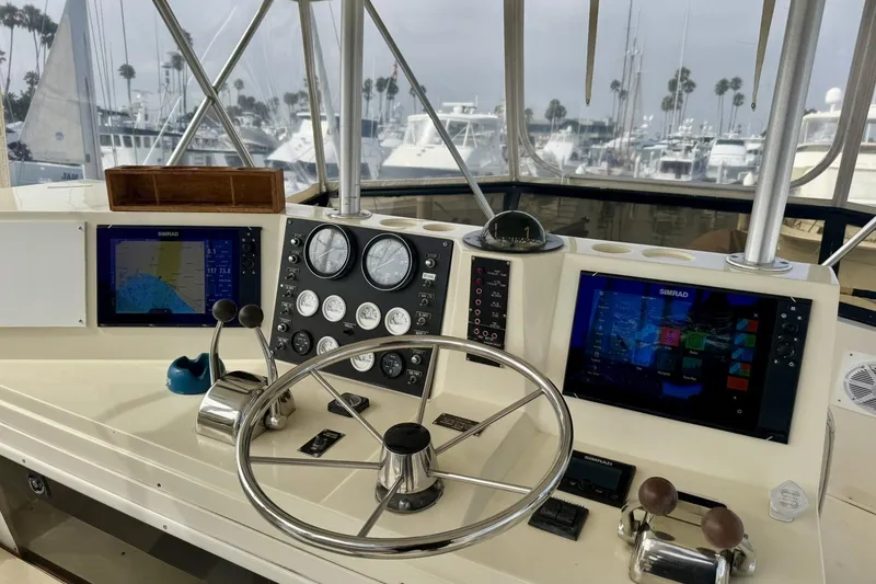 Slide: The Image of Helm of 1988 Viking 48 Convertible yacht with navigation instruments and steering wheel. - 14