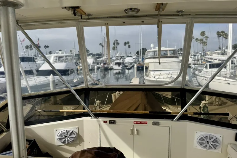 Slide: The Image of Interior view of a 1988 Viking 48 Convertible yacht docked at a marina. - 15