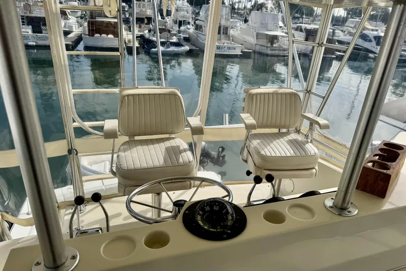 Slide: The Image of Helm of 1988 Viking 48 Convertible yacht with two captain chairs in marina. - 18