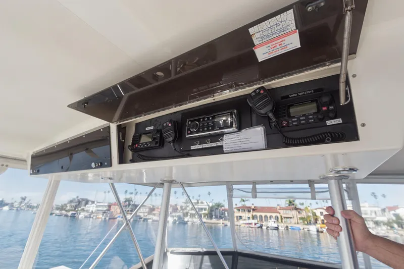 Slide: The Image of Control panel of a 1988 Viking 48 Convertible yacht with communication equipment. - 21