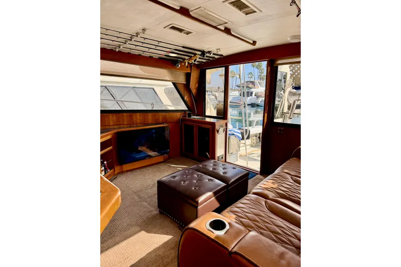 Slide: The Image of Interior of 1988 Viking 48 Convertible yacht with leather seating and fishing rods. - 27
