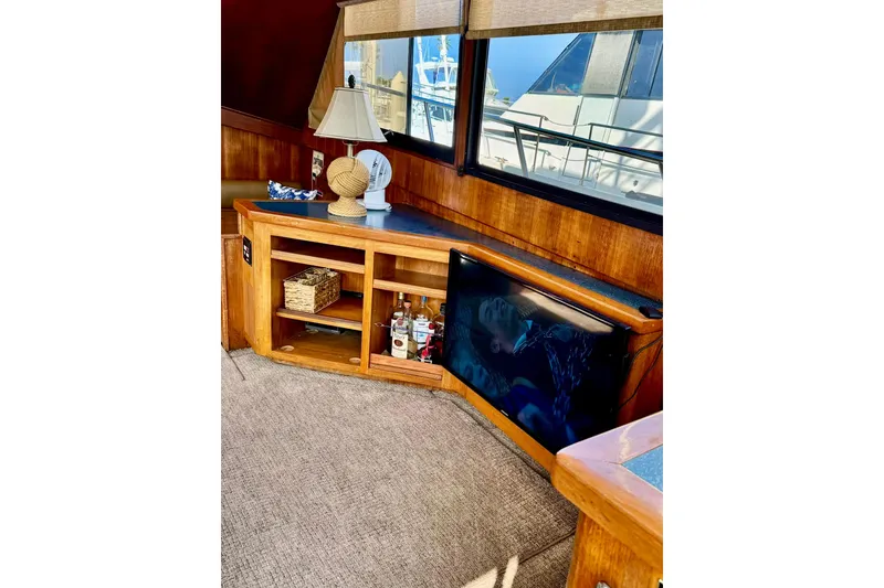 Slide: The Image of Interior of 1988 Viking 48 Convertible yacht with wooden cabinetry and a small TV. - 28
