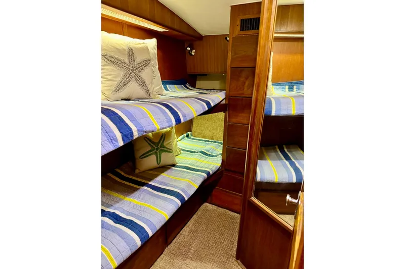 Slide: The Image of Cozy cabin with bunk beds in 1988 Viking 48 Convertible yacht, featuring nautical-themed decor. - 30