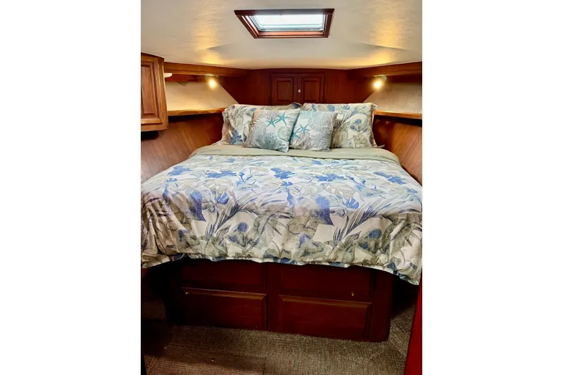 Slide: The Image of Cozy bedroom in 1988 Viking 48 Convertible yacht with floral bedding and wooden cabinetry. - 31