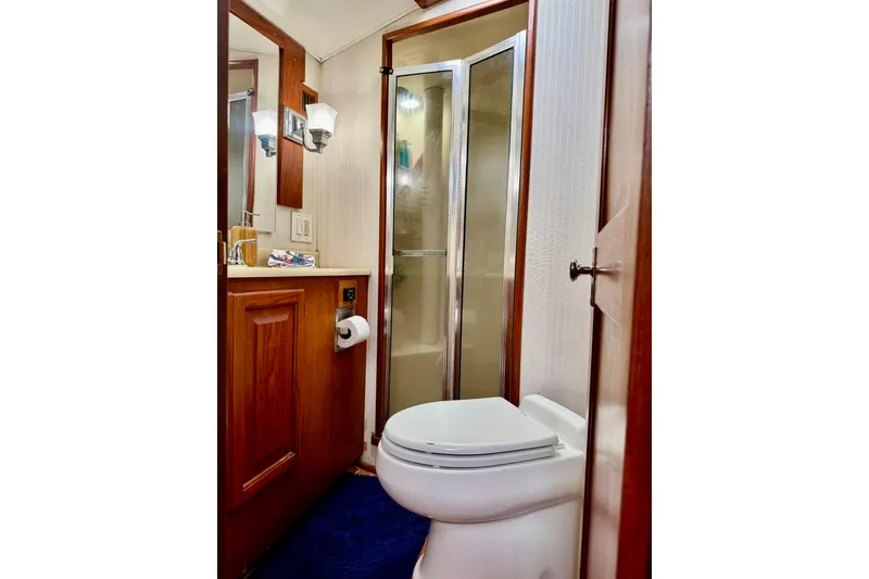 Slide: The Image of Bathroom interior of 1988 Viking 48 Convertible yacht with shower and wooden cabinetry. - 33