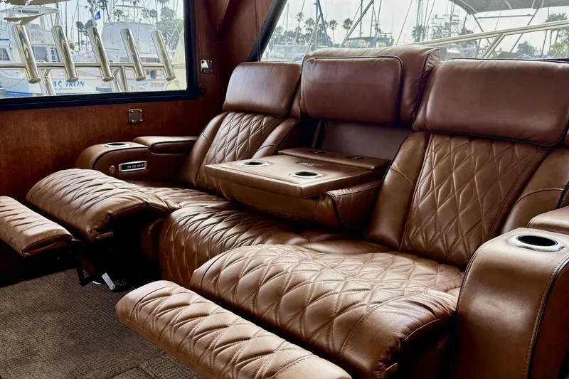 Slide: The Image of Luxurious leather seating inside a 1988 Viking 48 Convertible yacht, featuring recliners and cup holders. - 36