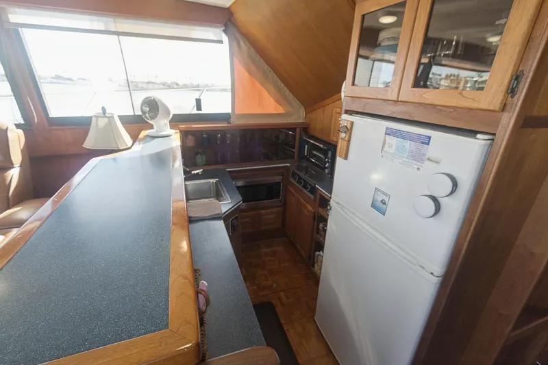 Slide: The Image of Interior of 1988 Viking 48 Convertible yacht kitchen with appliances and wooden cabinetry. - 38