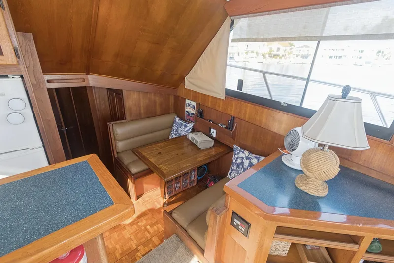 Slide: The Image of Interior of 1988 Viking 48 Convertible yacht with cozy dining area and nautical decor. - 39
