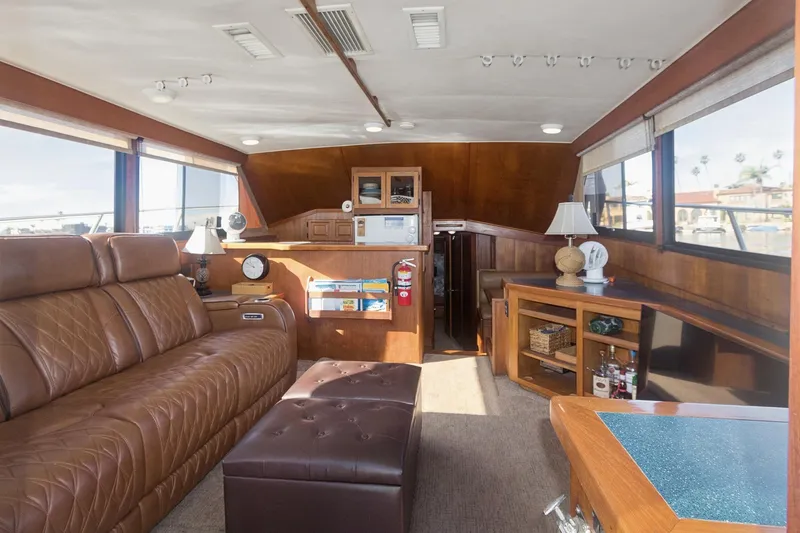 Slide: The Image of Luxurious interior of a 1988 Viking 48 Convertible yacht with leather seating and wooden accents. - 40