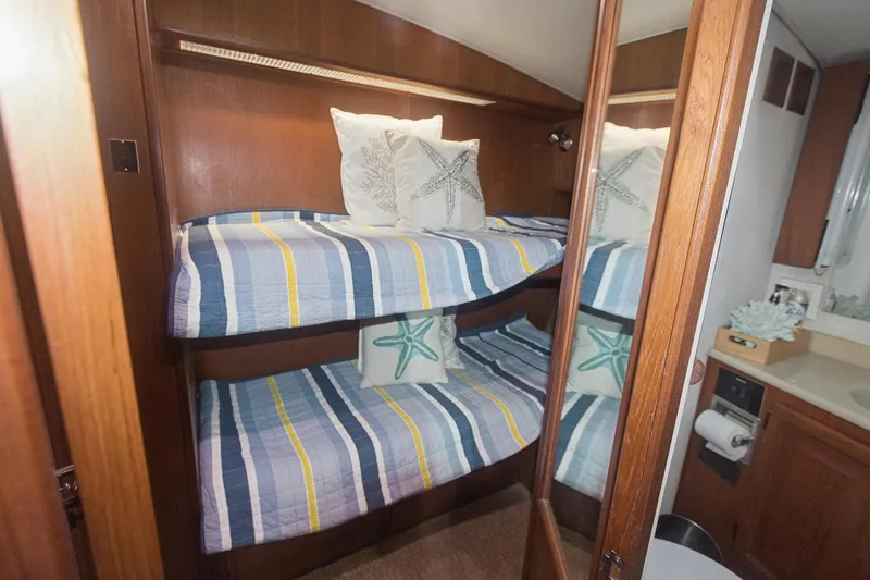Slide: The Image of Bunk beds in 1988 Viking 48 Convertible yacht cabin with striped bedding and starfish pillows. - 42