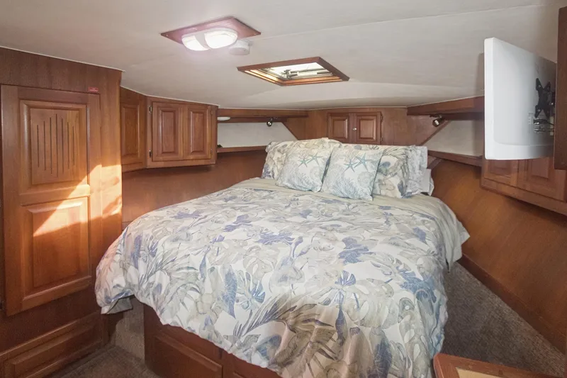 Slide: The Image of Cozy bedroom in 1988 Viking 48 Convertible yacht with floral bedding and wooden cabinetry. - 43
