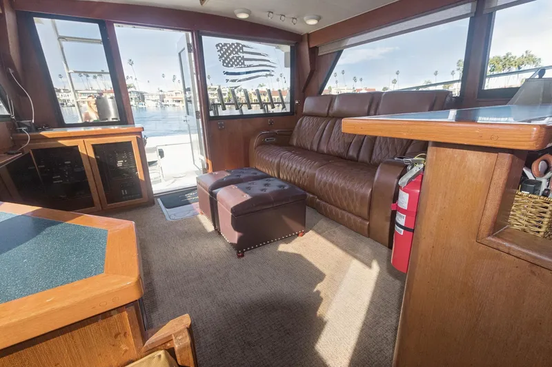 Slide: The Image of Interior of 1988 Viking 48 Convertible yacht with leather seating and waterfront view. - 45