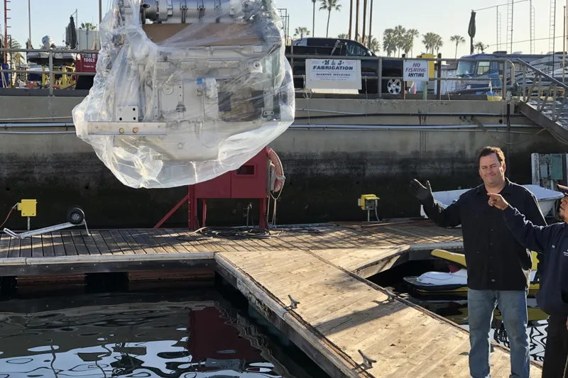 Slide: The Image of Men overseeing engine installation on 1988 Viking 48 Convertible yacht at dock. - 48