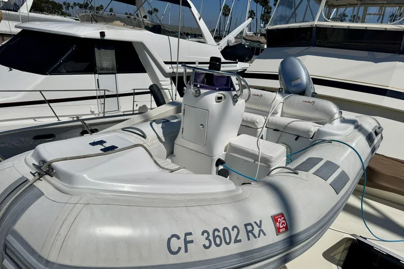 Slide: The Image of Inflatable boat docked beside a 1988 Viking 48 Convertible yacht. - 52