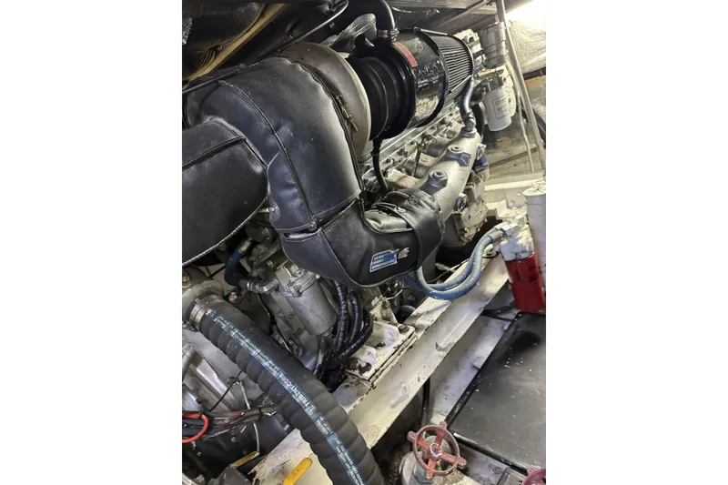 Slide: The Image of Engine compartment of a 1988 Viking 48 Convertible boat, showcasing detailed components. - 54