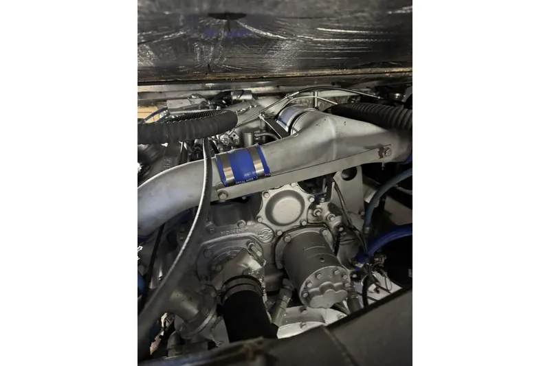 Slide: The Image of Engine compartment of a 1988 Viking 48 Convertible boat, showcasing mechanical components. - 55
