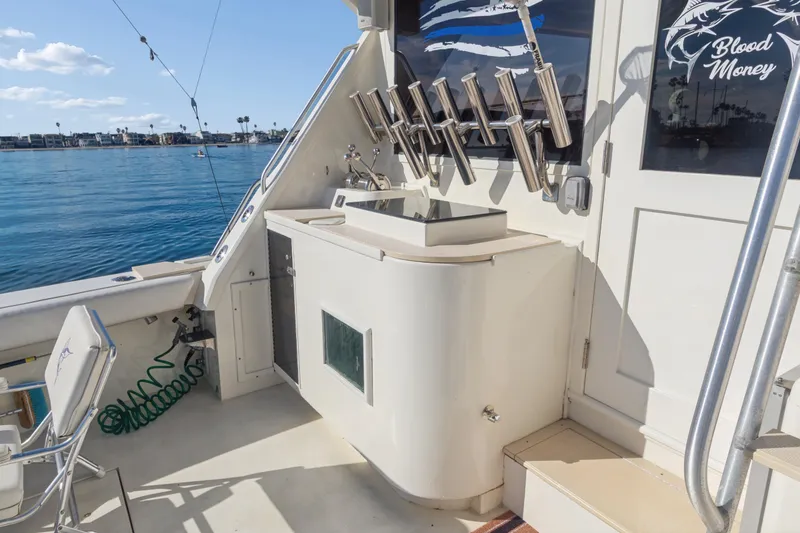 Slide: The Image of 1988 Viking 48 Convertible yacht deck with fishing rod holders and ocean view. - 9