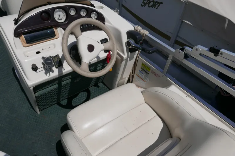 Slide: The Image of 2005 Bennington 257FS boat cockpit with steering wheel and control panel. - 6
