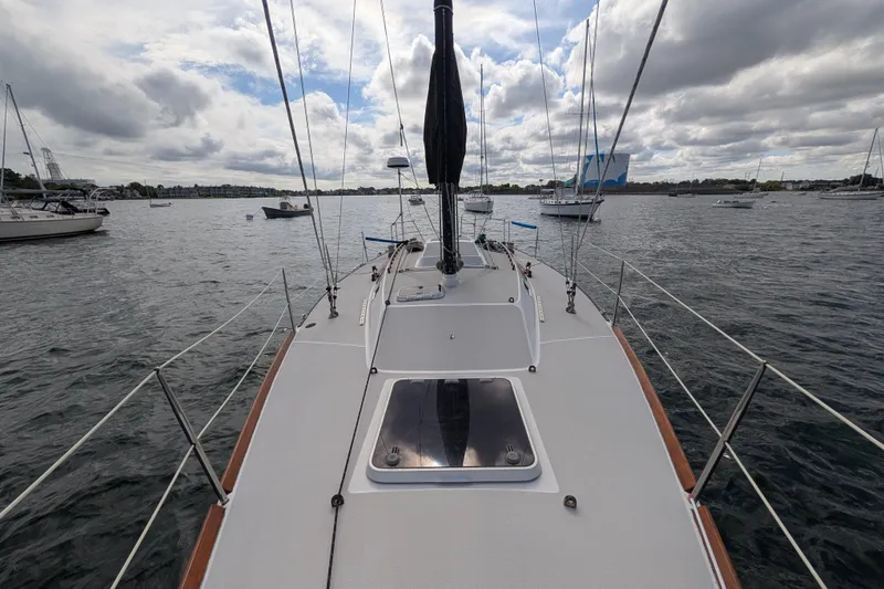 Slide: The Image of Sailboat deck view on water, Express 37 model, 1986, cloudy sky. - 12