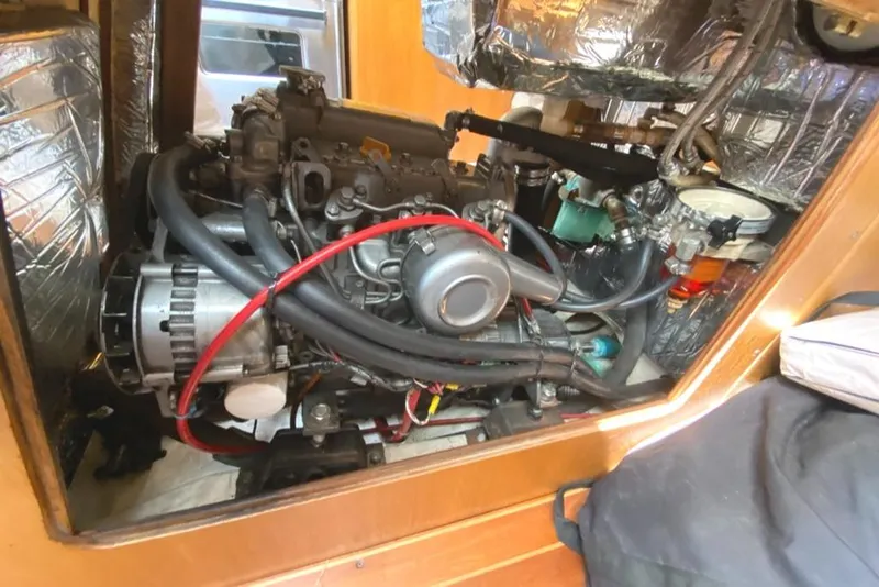 Slide: The Image of Engine compartment of a 1986 Express 37 sailboat, showcasing detailed mechanical components. - 32