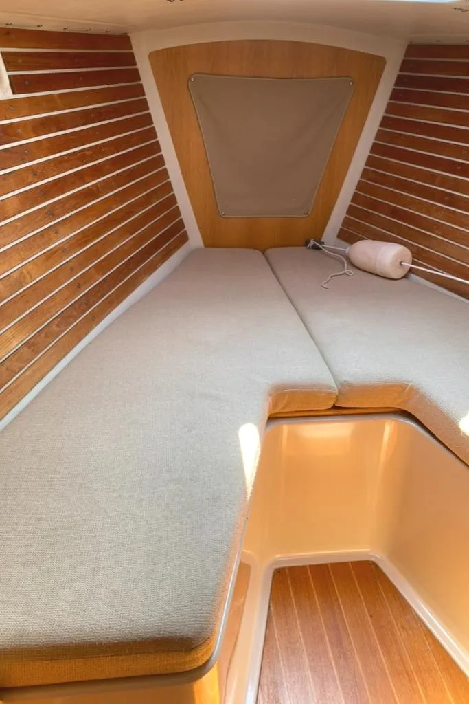 Slide: The Image of Cozy cabin interior of 1986 Express 37 sailboat with wooden paneling and cushioned seating. - 35