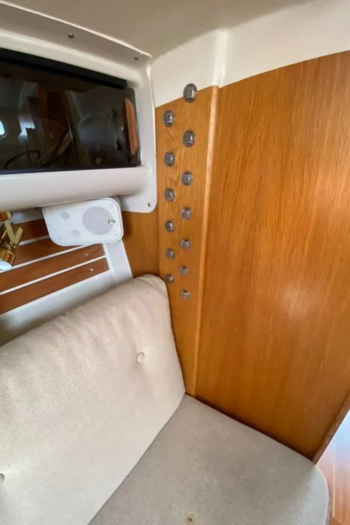 Slide: The Image of Interior of 1986 Express 37 sailboat with wood paneling and cushioned seating. - 38