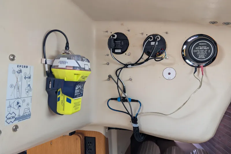 Slide: The Image of Interior of 1986 Express 37 boat showing EPIRB and wiring setup. - 52