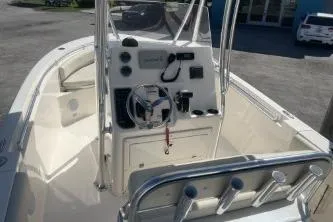 Slide: The Image of 2022 Cobia 237 Center Console boat with steering wheel and control panel. - 11