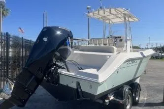 Slide: The Image of 2022 Cobia 237 Center Console boat with outboard motor on trailer. - 6